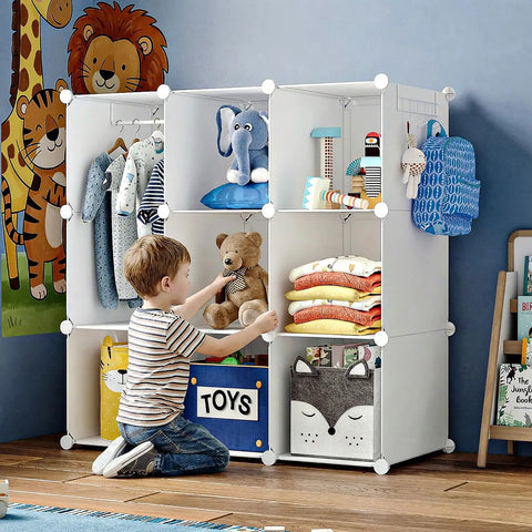 Portable Baby Wardrobe Closet For Kiddo Storage Organizer With Side Hooks DIY Modular Toy And Clothing Organizer Lightweight And Easy To Tidy Tiny Gear White displayed with toys and clothes.