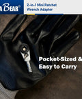 Gloved hand holding 2-In-1 Mini Ratchet Wrench Adapter With Magnetic One Quarter Inch Hex Bit Holder And One Quarter Inch Drive Socket Adapter, Compact Pocket Sized screwdriver and socket accessory.