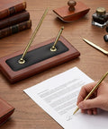 Wood And Leather Double Pen Holder Desk Set With Two Black Pens, Pro Grade Luxury Desk Stand in use with gold accents on desk