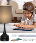 Touch Bedside Lamps Set Of 2 With Dual USB Ports, Nightstand Table Lamps For Bedroom And Living Room, Gray Fabric Shade And Black Vase Base, Easy Tap Control, USB Charging For Phone And Tablet, Bulbs Not Included shown with a child using a tablet.