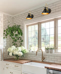 Kitchen with white tiles featuring a set of 2 industrial wall sconce lights modern 1 light vanity fixtures in matte black with brushed gold interior.