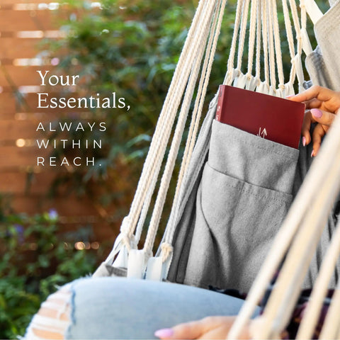 Close-up of Chill Out In A Cozy Full Body Hammock Chair With Foot Rest, showcasing built-in pocket with a book outdoors