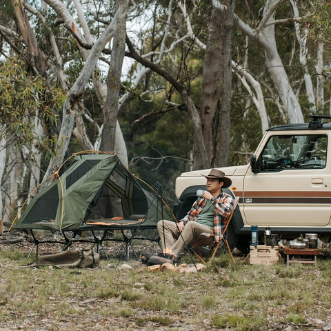 Person camping with Camping Cot Tent Combo For Solo Adventures Waterproof Off Ground Bed For Adults 1 Person Ultra Portable Easy Setup