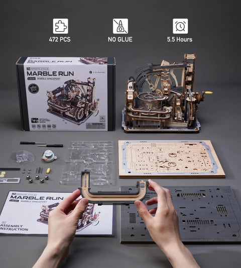 Motorized Wooden Marble Run Puzzle For Adults LGC01 Marble Spaceport parts and assembly instructions displayed on a table.