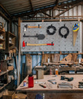 Garage workshop with tools hung on Heavy Duty Magnetic Hooks Set 40 Lbs Holds Cables Ropes Wires Cordless Tools For Garage Workshop RVs Cruises Pickup Trucks 4 Pack Tool Hangers Industrial Strength Magnetic Power on a board.