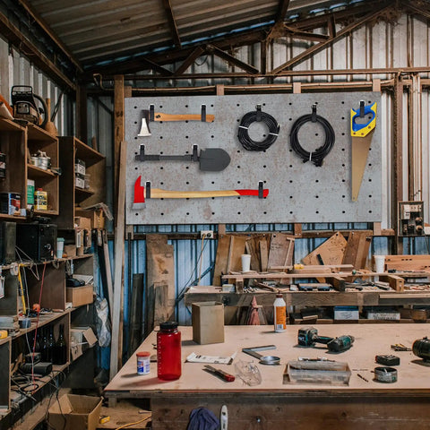 Garage workshop with tools hung on Heavy Duty Magnetic Hooks Set 40 Lbs Holds Cables Ropes Wires Cordless Tools For Garage Workshop RVs Cruises Pickup Trucks 4 Pack Tool Hangers Industrial Strength Magnetic Power on a board.