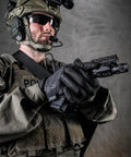 Person in tactical gear wearing black 0.5mm AX-Suede Tactical Gloves With Tight Fit And Precision Feel For High Dexterity In Airsoft.