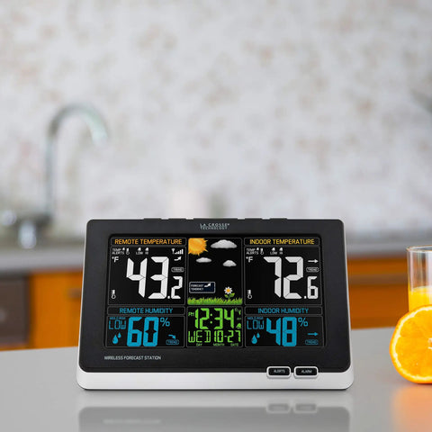 Wireless Color Weather Station With Mold Indicator on kitchen counter, displaying indoor/outdoor temperature, humidity, and forecast