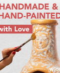 Hand painting a Medium Outdoor Chiminea Fireplace For Patio with clay, rain lids, and rustic vibe
