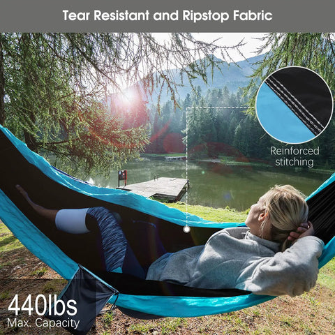 Person reclining in Camping Hammock With Built In Mosquito Net And Rain Fly, Heavy Duty Tree Straps, Nylon Parachute Fabric