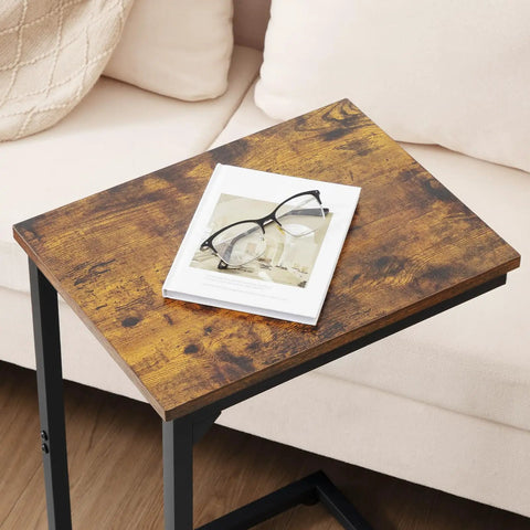 C Shaped End Table That Slides Under Couch For Small Spaces TV Tray Snack Table And Laptop Desk Brown Living Room Side Table For Sofa Or Recliner Perfect Under Couch Beverage Holder with book and glasses on top