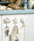 Heavy Duty Cast Iron Coastal Wall Hooks Set of 3 Legit Retro Charm Slick with crab, starfish, and seashell designs for bathroom use.
