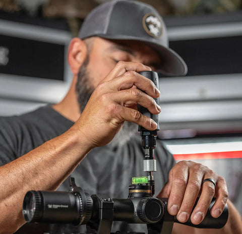 Individual using Pro Torque Wrench For Riflescopes With 10 To 90 In Lbs Torque Range 13 Bit Kit on mounted riflescope