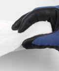 Ceramic fiber insulation blanket, 1 in thick, 16 x 48 in, white; held by a blue and black work glove.