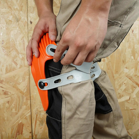 Person wearing Ultraflex Non-Skid Kneepads With Flexible Design, securing orange plastic gear for construction and DIY use