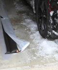 Water Activated 5 Foot Sandless Flood Barrier 4 Pack Self-Inflating Absorbs Water And Rises To Form A Tight Barrier For Quick Flood Control Black placed near a snowy car in a garage