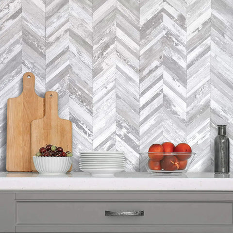 10 Sheet Herringbone Peel And Stick Backsplash In Vintage White Wood Look PVC for kitchen with cutting boards and fruit bowls.