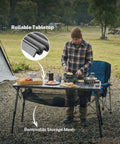 Man using 50 Inch Camping Table With Adjustable Height Legs For Uneven Ground, Easy Setup Portable Folding Aluminum Roll-Up Table With Mesh Pocket for outdoor cooking.