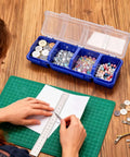 Person crafting near 6 Pack Screw Organizer Box With Lid For Garage And Workshop Four Compartments Small Parts Bins.