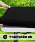 Six Pack Rectangle Picnic Table Cloth With Elastic Fitted Edge Waterproof Spillproof Polyester Table Cover For Indoor Outdoor Use 30x72 Inches Black Great For Camping Patio And Events being placed on a table outdoors.