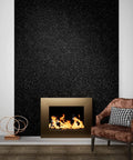 Living room with black peel and stick glitter wallpaper behind fireplace, featuring ultra fine glitter for glam upgrade.