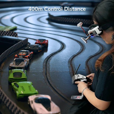 Person using remote to control mini RC cars on track with Ultra Compact Four Channel Gyro RC Receiver for Mini Cars