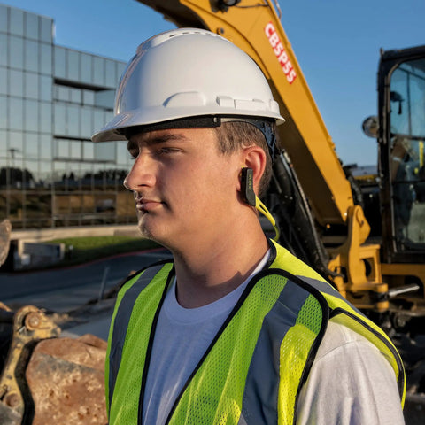 Person wearing Wave Banded Ear Plugs With Flexible Neckband For Easy Access Gray Yellow Noise Reduction To 22dB on construction site