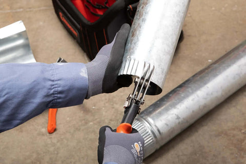 Nine and Three Quarters Inch Five Blade Hand Crimper for Gutters, Downspouts, and Metal Pipe Connections in use on piping