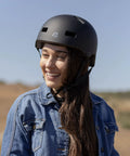 Person wearing All-In-One Adult Helmet For Biking, Skating, Scooters And Longboards, Protective ABS Shell With EPS Foam, Matte Black, Large.