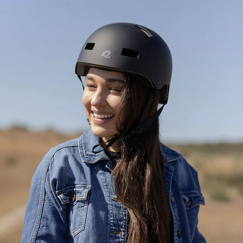 Person wearing All-In-One Adult Helmet For Biking, Skating, Scooters And Longboards, Protective ABS Shell With EPS Foam, Matte Black, Large.