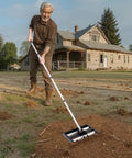 Person using Updated Lawn Leveling Rake With Roller 17 Inch By 10 Inch Stainless Steel Lawn Leveler on a yard