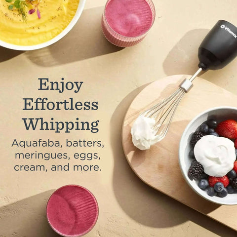 Slick Two Speed Immersion Blender With Whisk Attachment And Knockout 350 Watt Motor For Effortless Soup Blending Sauce Crafting And No Fuss Smoothie Mixing In Modern Black with whisk and bowls of cream and smoothies.