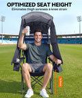 Man sitting in Grab And Go Camping Chair With Canopy Shade And UPF Fifty Plus Protection, holding drink on sports field