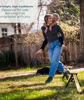 Person using Backyard Slackline Kit Freestanding Slackline System for Kids and Adults on grass with child