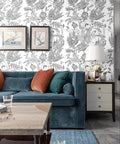 Living room with Peel And Stick Black White Lotus Lily Damask Wallpaper Mural For Easy DIY Decor behind a blue sofa