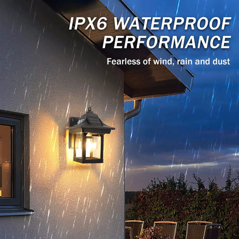 All Night Solar Wall Lights With Dusk To Dawn Motion Sensor 3 Lighting Modes Wireless Exterior Porch Lights Wall Mount Patio Fence Lanterns Black 2 Pack 2200mAh Battery Plugless No Wire Setup illuminated on a rainy night showing IPX6 waterproof performance on house wall.