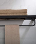 Stelios Matte Black Bathroom Shelf With Towel Bar Built To Last Solid Brass Construction Rugged And Rust Resistant Finish Built In Bar For Towels And Accessories KEA 19942MB Wall Mount. View from above with folded towels, mounted on light tile wall.