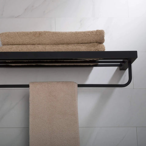Stelios Matte Black Bathroom Shelf With Towel Bar Built To Last Solid Brass Construction Rugged And Rust Resistant Finish Built In Bar For Towels And Accessories KEA 19942MB Wall Mount. View from above with folded towels, mounted on light tile wall.