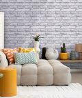3D Faux Brick Peel And Stick Tiles Set Of 10 Small 11.8 By 11.8 Inch PVC Wall Panels in warm white used as living room decor