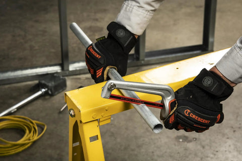 Person using Ten Inch High Tension Compact Hacksaw With Dual Material Handle For Easy Grip And Flush Cuts on metal pipe