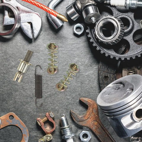 Heavy Duty Brake Adjustment Tool Kit With Metal Hold Down Springs And Pins For Drum Brakes In Construction Machinery, Beefed Up Friction Stability, Quick Spring Tool For Fast Stops, And Easier Loader Disc Brake Access. Metal brake springs and pins laid out on gray mat.