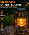 Antique Style Battery Operated Lantern with IP65 waterproof rating, glowing in rain on a stone surface with garden backdrop