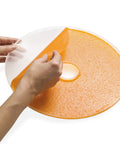 Smooth Operator Digital Electric Food Dehydrator With Stackable Trays showing a hand peeling orange fruit leather off a tray.