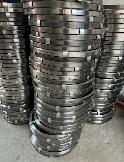 Stacked rolls of Heavy Duty Flat Iron Drain Cleaning Steel Tape for effective manual auger use against stubborn clogs.