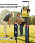 62 Inch Extendable Phone Tripod And Selfie Stick For Golf Training With Wireless Remote And Universal Phone Holder displayed outdoors.