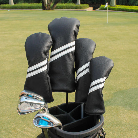 4 Piece Golf Head Cover Set For Drivers Fairway Woods And Hybrids With Interchangeable Tags Waterproof Black Protection No Hassle Universal 460cc Driver Fit Durable Plush Fur Easy On And Off For All Woods And Hybrids displayed on golf bag at a course.