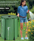 Woman using a green 100 Gallon Collapsible Rain Barrel With Water Level Indicator For Easy Garden Watering And Farm Irrigation
