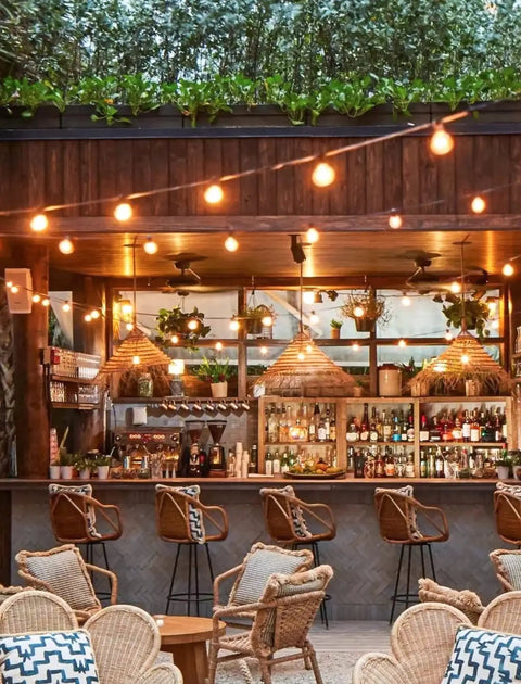 Outdoor String Lights 25 Feet G40 Globe Bulbs With 27 Edison Glass Bulbs Plus 2 Spares illuminating a cozy patio bar setup.