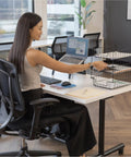 Person organizing papers in a Wire Desk Tray Organizer For Letter And Legal Size Papers Black 5 Inch Buildable File Bin on a desk.