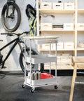 3 Tier Rolling Utility Cart With Drawer And Wood Tabletop Maple Finish Slick Mobile Side Table And Nightstand Slim Storage Trolley For Bedroom Bathroom Office And Art Supplies Easy Roll Casters in a garage setting